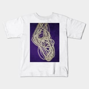 Pearls and beads on a purple background Kids T-Shirt